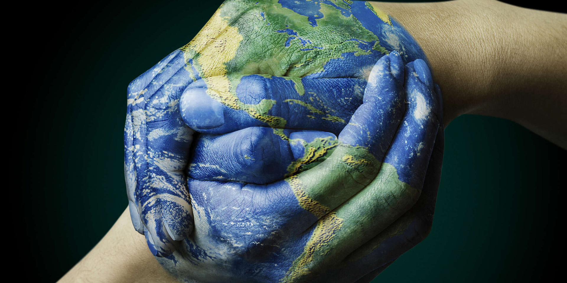 earth painted on hands held together